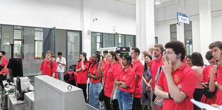 A group of people in red shirtsDescription automatically generated